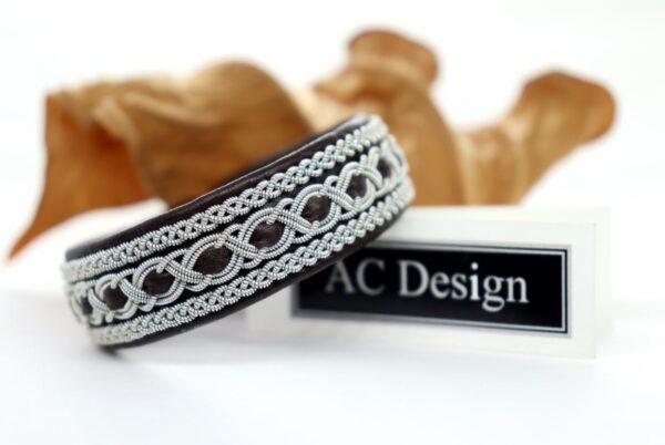 Elegant Sami bracelet named Trudvang. Handmade in genuine reindeer leather and pewter wire that contains 4 precent sterling silver. Label AC Design.